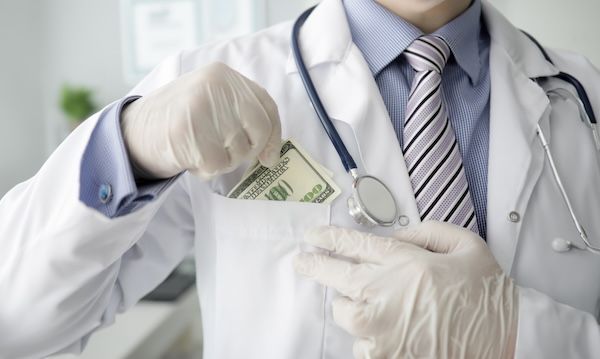 Un medico con i guanti bianchi spinge con forza