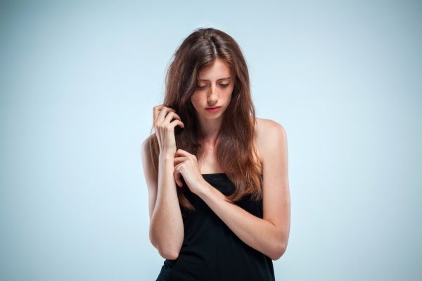 Ragazza in posa timidamente e tristemente davanti alla telecamera