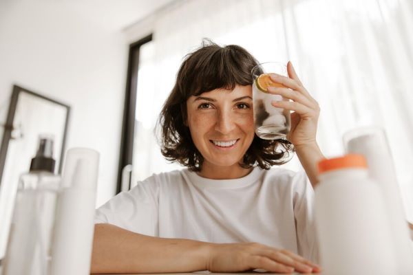 La signora beve un bicchiere d'acqua